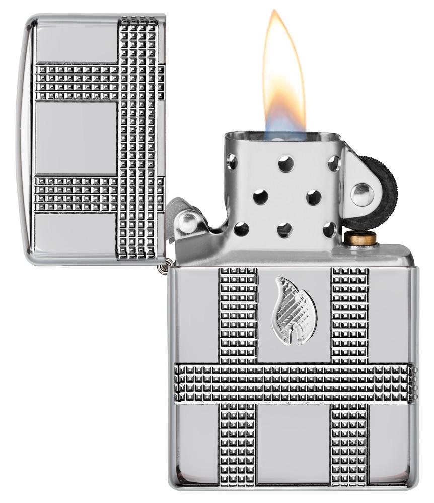 Geometric Design High Polish Chrome Windproof Lighter with its lid open and lit
