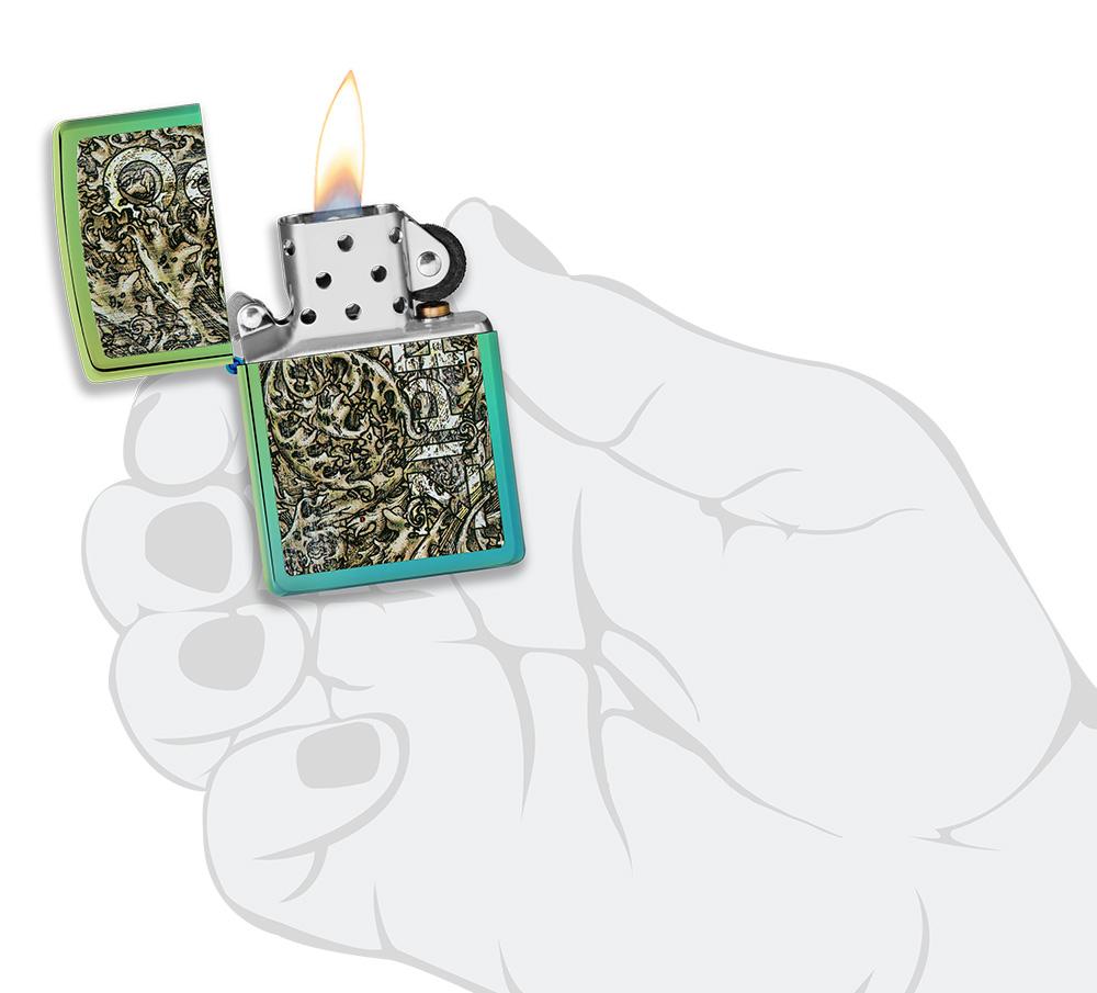 Zippo Design High Polish Teal Windproof Lighter lit in hand
