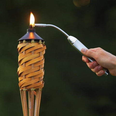 Lifestyle image of Chrome Flex Neck Utility Lighter lighting a tiki torch