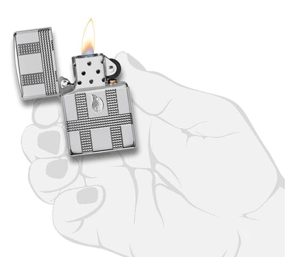 Geometric Design High Polish Chrome Windproof Lighter with its lid open and lit, in hand