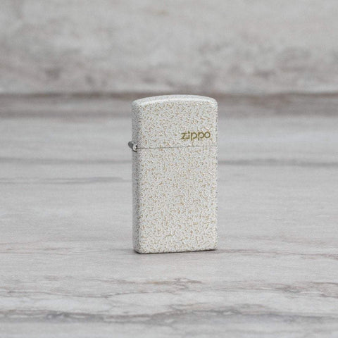 Lifestyle image of Slim® Mercury Glass Zippo Logo Windproof Lighter standing on a marble surface